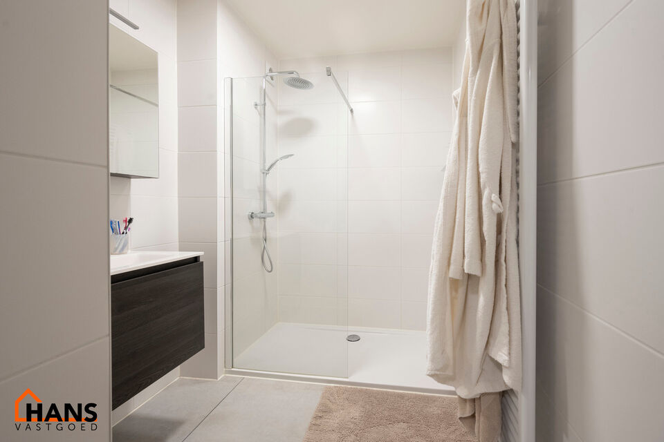 Inkomhal; apart toilet; leefruimte; keuken met kasten, kookplaat, dampkap, oven, spoelbak en ruimte voor een eigen koelkast en vaatwasser; badkamer met inloopdouche, lavabo in meubel, spiegelkast en handdoekdroger; 2 slaapkamers waarvan de kleine toegang 