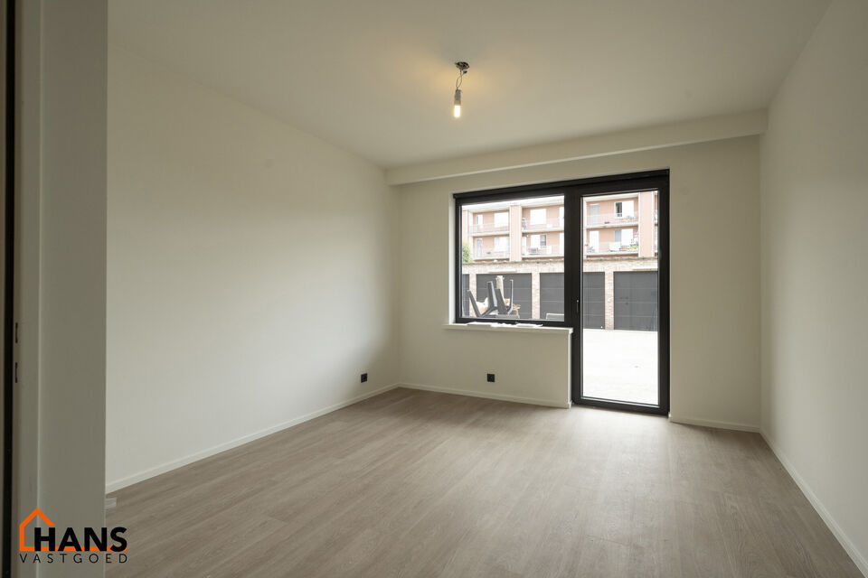 Op de gelijkvloers van een kleinschalig gebouw (zonder lift) bevindt zich dit stijlvol gerenoveerde appartement. Bij binnenkomst treft u een inkomhal met ruimte voor een vestiairekast en een gastentoilet met wastafelmeubel.

De ruime en lichtrijke woonkam