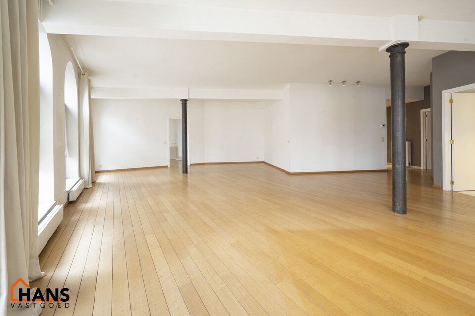 Inkomhal met vestiairekast; apart toilet met wastafel; riante, lichtrijke woonkamer van 80m² op een houten vloer met ingemaakte kasten; ruime keuken, volledig ingericht met kasten, lades en alle toestellen (gasfornuis, dampkap, vaatwasser, combi-oven, ko