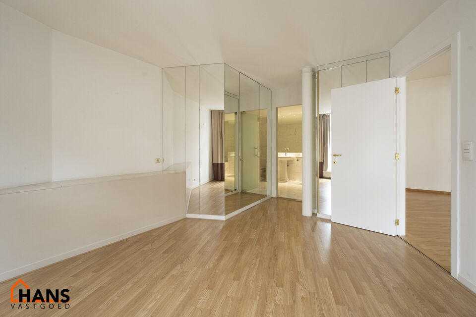 Inkomhal met vestiairekast; apart toilet met wastafel; riante, lichtrijke woonkamer van 80m² op een houten vloer met ingemaakte kasten; ruime keuken, volledig ingericht met kasten, lades en alle toestellen (gasfornuis, dampkap, vaatwasser, combi-oven, ko